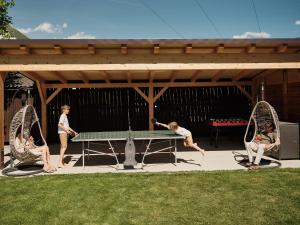 a group of people playing a game of ping pong at Residence Montani in Laces