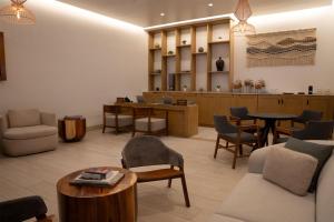 a waiting room with chairs and tables and a waiting area at Hilton Tulum Riviera Maya All-Inclusive Resort in Tulum +134 photos