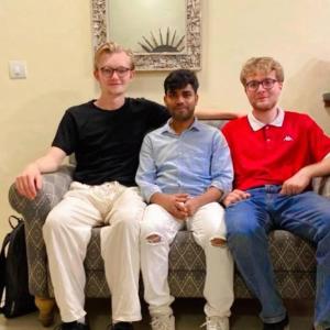 a group of three men sitting on a couch at Bed & Chai in New Delhi
