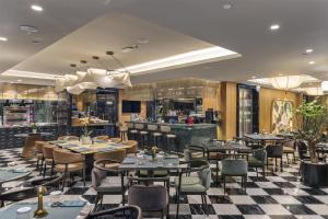 a restaurant with tables and chairs and a bar at Palazzo Donizetti Istanbul, Tapestry Collection by Hilton in Istanbul +58 photos