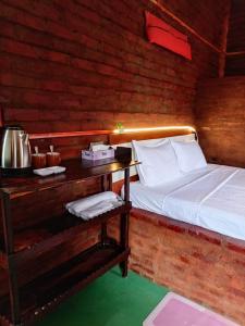 a bedroom with a bed and a table with at Padiwatte Residencies in Kandy