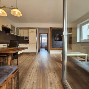 a kitchen with a table and a dining room at Apart Hannah in Uderns