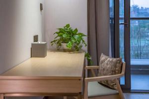 a wooden desk with a chair and a plant at Lebanshan Hotel Chongqing Yongle in Chongqing +29 photos