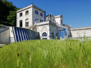 an old building with tall grass in front of it at ibis Styles Angouleme Centre in Angoulême