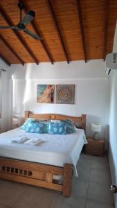 a bedroom with a large bed with a wooden ceiling at Casa de Playa Antawara in El Porvenir +31 photos