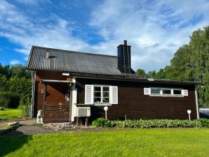 a wooden house with a tower on top of it at Schwedentraum in Burseryd