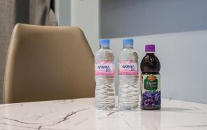 two bottles of water sitting on top of a table at Daegu Brown Dot Hotel Kyungpook National University in Daegu
