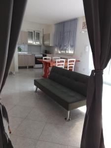 a living room with a couch and a table at La casetta in Martina Franca +12 photos
