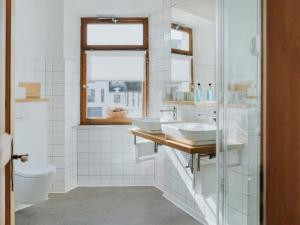 a bathroom with two sinks and a toilet at MYA Weinland Hotel Kobern-Gondorf in Kobern-Gondorf +72 photos