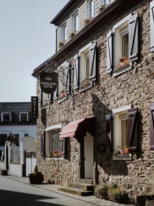 a stone building with a sign on the side of it at MYA Weinland Hotel Kobern-Gondorf in Kobern-Gondorf
