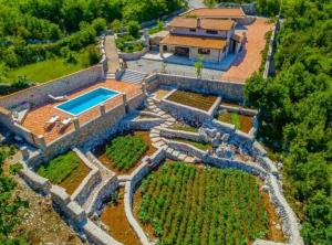 an aerial view of a house with a swimming pool at Rustic Haven Villa in Vrgorac