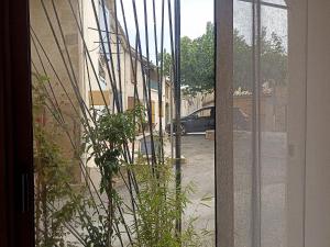 a view of a street through a glass door at Studio privé - maison de village in Valensole +7 photos