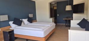 a bedroom with a large bed with blue walls at Hotel Barca Blu in Orselina +16 photos