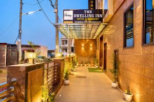 a building with a sign that reads the dwelling inn hotel function at The Dwelling Inn in Greater Noida
