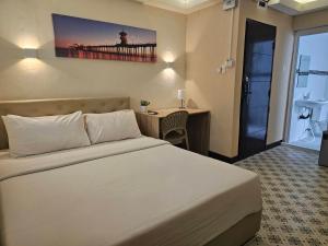 a hotel room with a bed and a desk and a bed and a room at Cozy rooms Asoke in Bangkok +24 photos