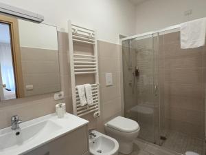 a bathroom with a toilet and a sink and a shower at RIAMA AGRIRESORT in Naples