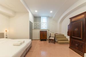a bedroom with a bed and a chair and stairs at RIAMA AGRIRESORT in Naples +173 photos