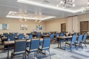 a conference room with tables and blue chairs at Cambria Hotel Phoenix Chandler - Fashion Center in Chandler +43 photos