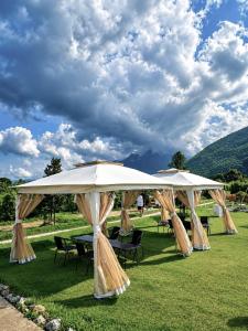 a group of tables and umbrellas in a field at Paradise Resort & Cafe in Ban Mae Khon