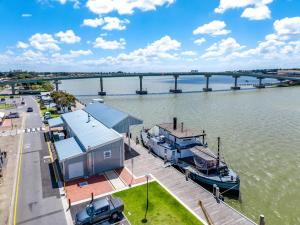 a boat docked at a dock on a river at Hutchinson House in Goolwa