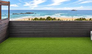 a view of the beach from a house with a fence at Ocean2YouResort SokchoSeorakBeach Hotel&Condo in Sokcho