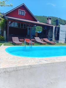 a swimming pool in front of a house at Vikendica Andrija Drina in Gvozdačko Polje
