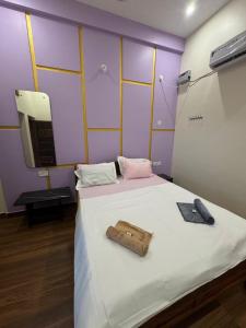 a bedroom with a large white bed with a mirror at Golden Waves Guest House in Mahabalipuram