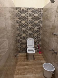 a bathroom with a toilet and a sink at Golden Waves Guest House in Mahabalipuram