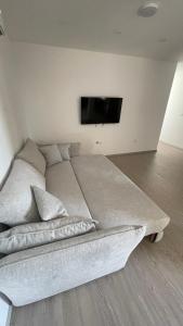 a bedroom with a bed and a flat screen tv at SunVillaTuzi in Tuzi