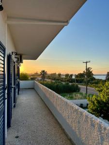 a balcony with a view of the ocean at Errant Blue House Kyllini in Kyllini