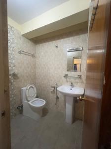 a bathroom with a toilet and a sink at Namaste Apartment in Pokhara