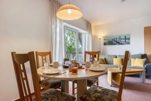a dining room with a table and chairs and a living room at Sonnengelb - Fulgenhaus in Klein Bollhagen +17 photos