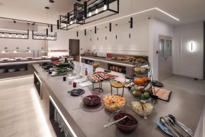 a kitchen with lots of food on a counter at Blue Waves Resort in Malinska