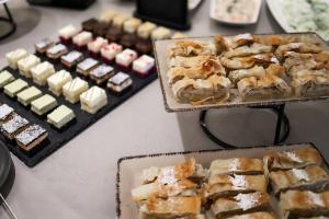a table topped with different types of pastries and desserts at Blue Waves Resort in Malinska