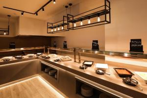 a restaurant with a long counter with dishes on it at Blue Waves Resort in Malinska
