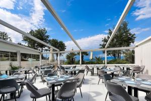 a view of a restaurant with tables and chairs at Blue Waves Resort in Malinska