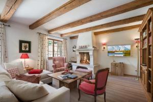 a living room with a couch and a fireplace at Chalet Lebenberg Kitzbühel in Kitzbühel