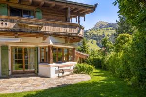 a house with a bench in front of it at Chalet Lebenberg Kitzbühel in Kitzbühel