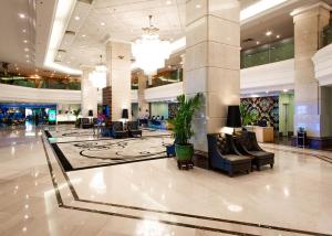 a lobby with couches and chairs in a mall at Promenade Hotel Kota Kinabalu in Kota Kinabalu +68 photos