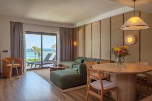 a living room with a couch and a table at Sarena de Muro Resort Mallorca, part of Destination by Hyatt in Playa de Muro +31 photos