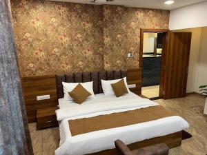 a bedroom with a large bed in a room at Hotel Central Point in Indore