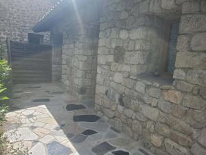 a stone building with the sun shining through a window at Tranquillité in Le Cheylard
