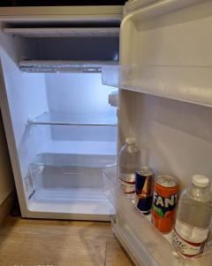 an open refrigerator with two cans of drinks in it at Relais Principe Umberto in Naples