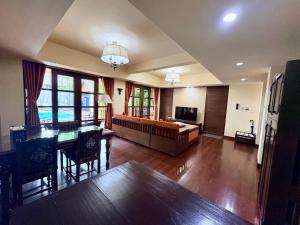 a large living room with a couch and a table at Shewe Wana Suite Resort in Chiang Mai