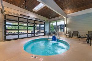 a swimming pool in a house with a patio at Fairway Inn and Suites, an Ascend Collection Hotel in Mishicot