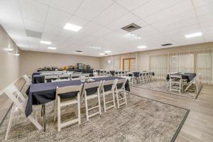 a banquet hall with tables and chairs in a room at Fairway Inn and Suites, an Ascend Collection Hotel in Mishicot +37 photos