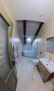 a bathroom with a toilet and a sink and a tub at Oborri Shkodran Boutique Hotel in Shkodër +86 photos