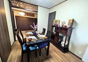 a dining room with a table and chairs and a table and chairsktop at 忍 Shinobi House in Yokohama