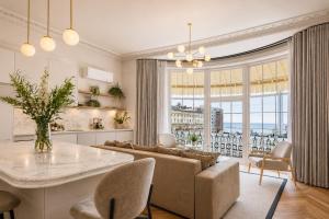 a living room with a couch and a table at Sigma Plus Regency Square Suites near Brighton Beach in Brighton & Hove
