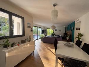 a living room with a table and a couch at La Maison Bernard in Roquefort-la-Bédoule